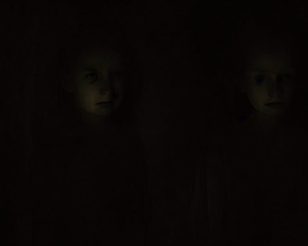 Faintly visible children's faces in dark background