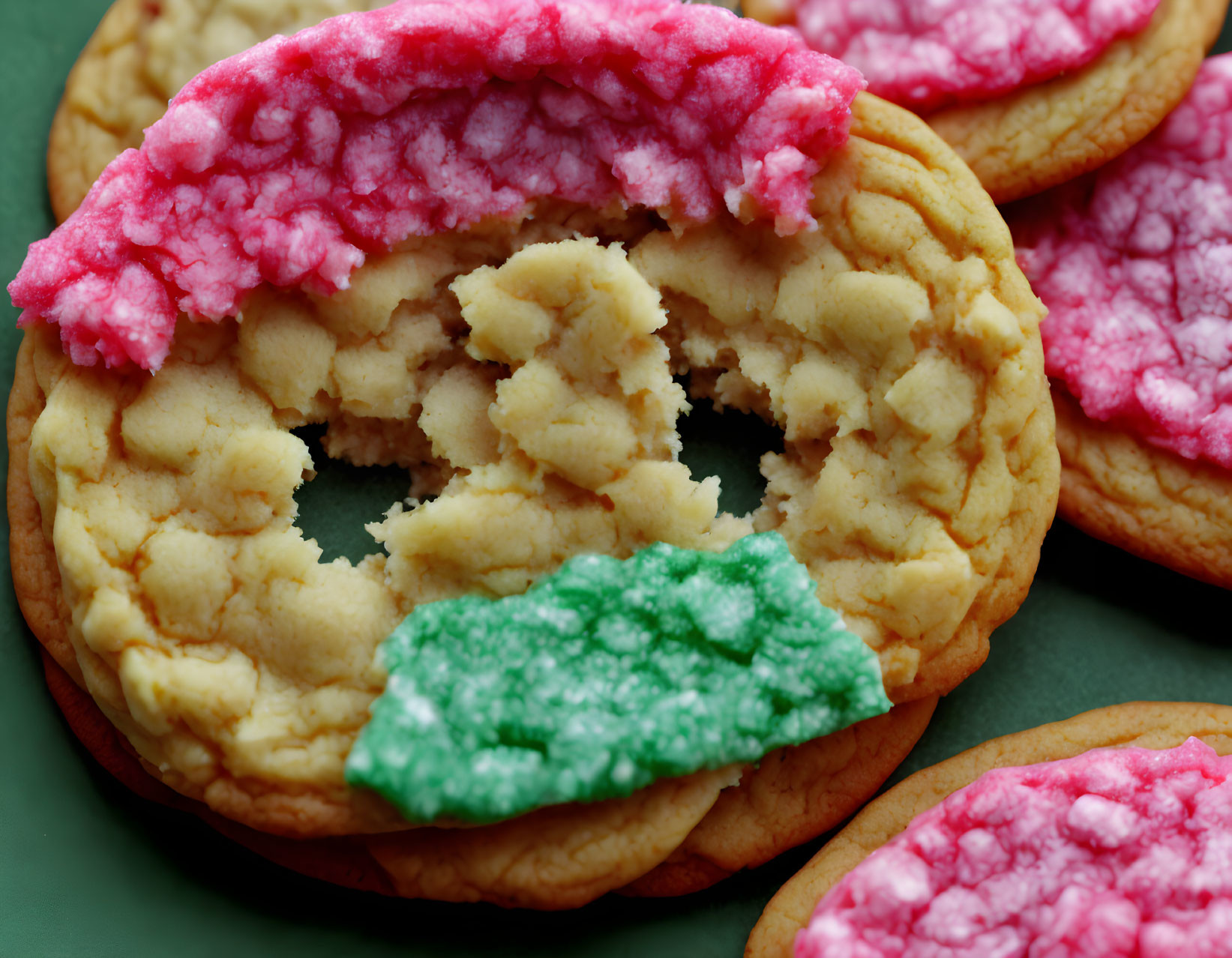 Cracked sugar cookie with pink frosting among others