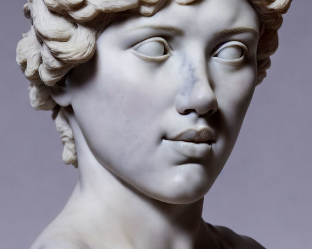 Classical marble sculpture of person with curly hair and serene expression