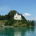 Majestic fairy-tale castle in lush landscape with mountains