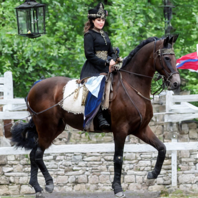 Traditional attired woman riding horse with blue and white flag, rustic background.