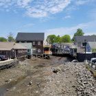 Picturesque waterside village with boats, docks, and traditional houses