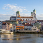 Fantasy palace with blue, golden domes, arches, and bridge over water.