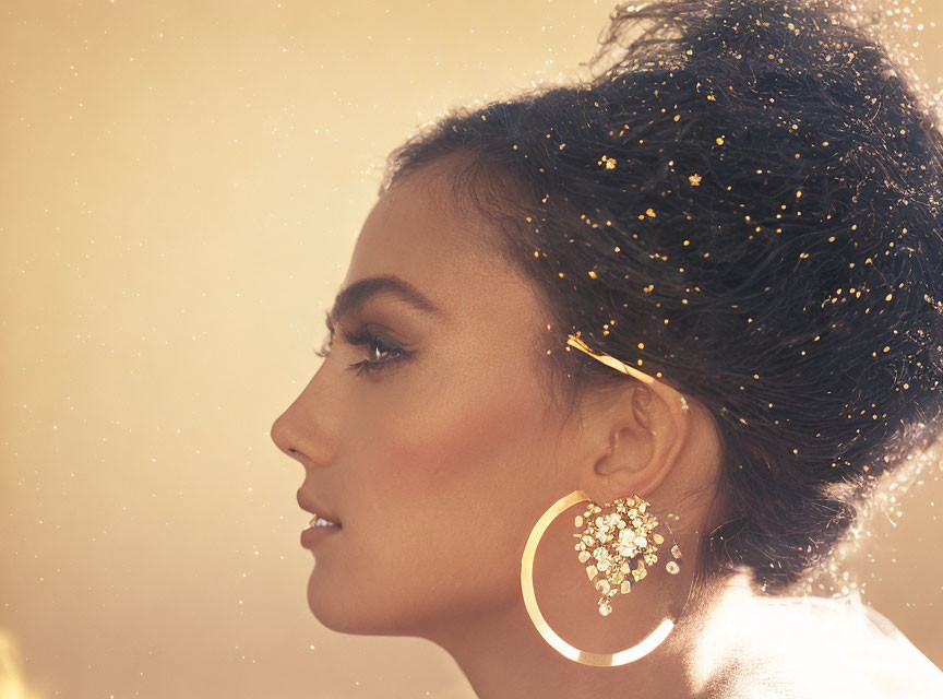 Woman Profile with Glitter Hair & Elegant Earrings on Golden Background