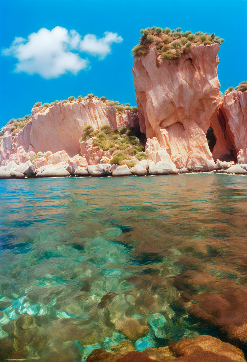 Majestic red cliffs overlooking turquoise waters and greenery