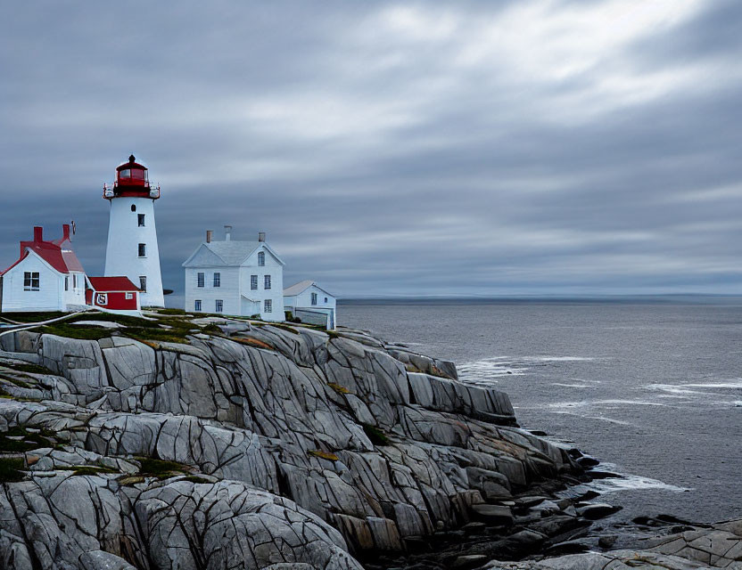 Scenic lighthouse on rugged cliffs under dramatic skies