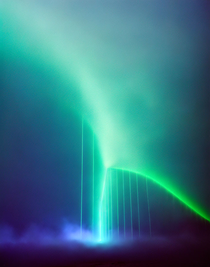 Vibrant green aurora borealis over bridge silhouette in soft blues and purples