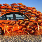 Orange Car Covered in Large Red Crabs on Sandy Beach