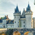 Majestic fairy-tale castle with blue spires in snow-covered landscape