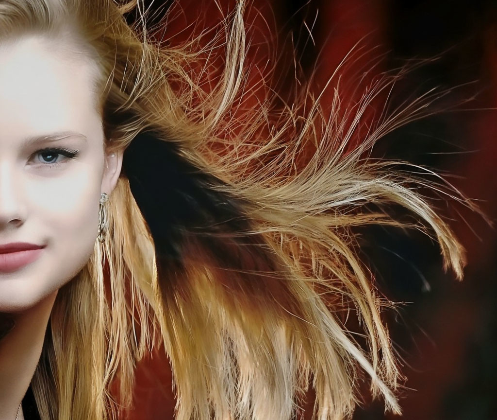 Blonde woman with earring and wind-blown hair portrait