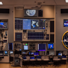 NASA-themed control room with workstations and large screens