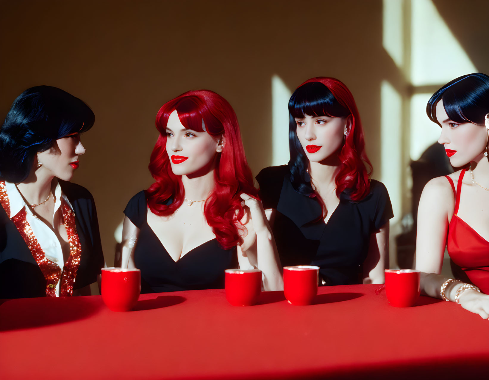 Four Women with Red and Black Hairstyles at Table with Red Cups
