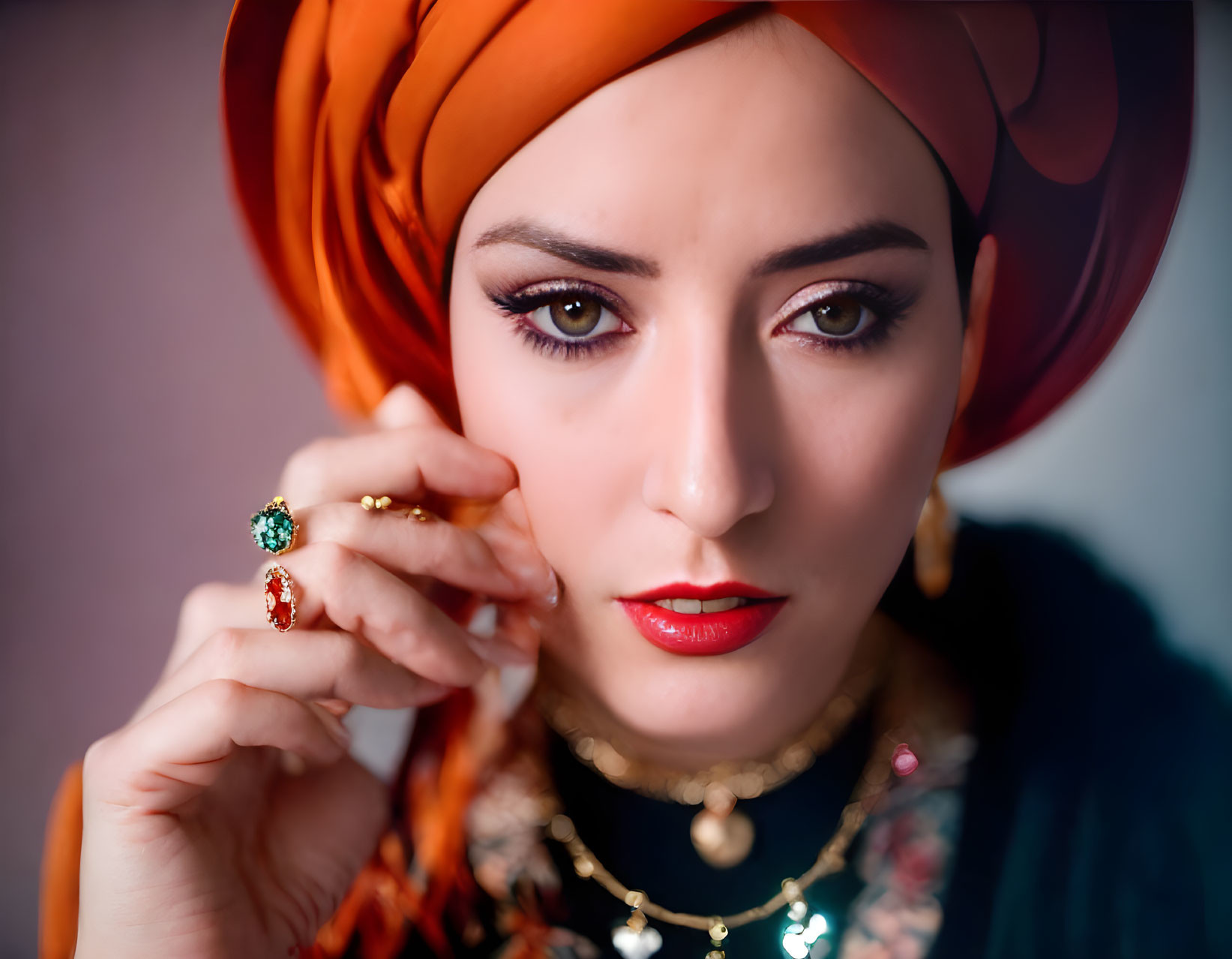 Woman in Orange Turban with Gold Jewelry and Gemstone Rings