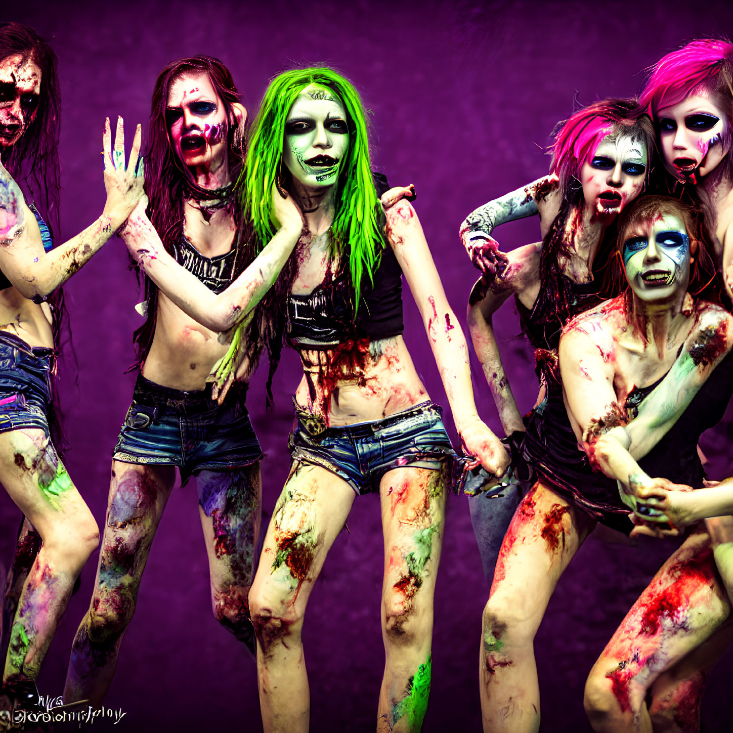 Group of five people with zombie-style makeup and fake blood on purple background