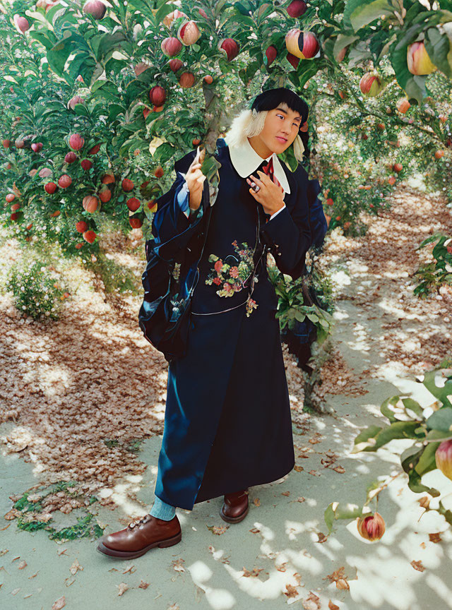 Person in Floral Embroidered Coat Painting Among Apple Trees