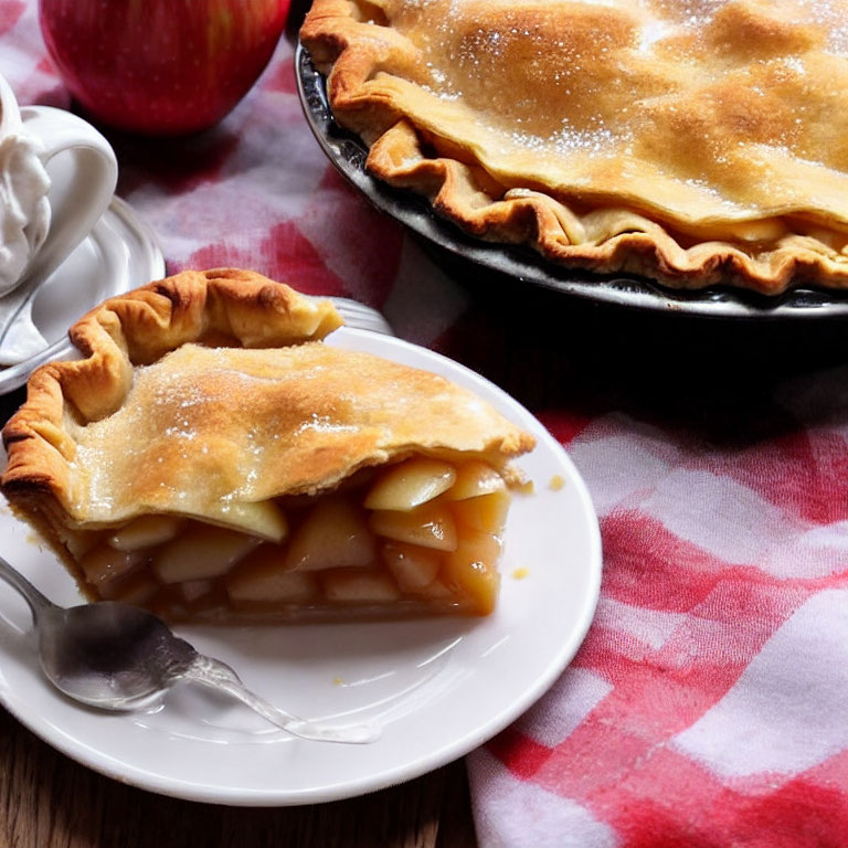 Golden-crusted apple pie with juicy filling on plate.