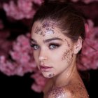 Digital portrait: Woman with butterfly and floral face art, pink flowers, butterflies