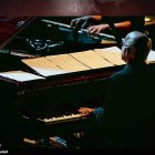 Bald Man Playing Piano in Cosmic Setting