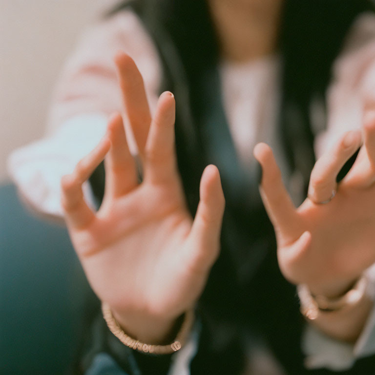 Person's Hands Gesturing in Close-Up Shot