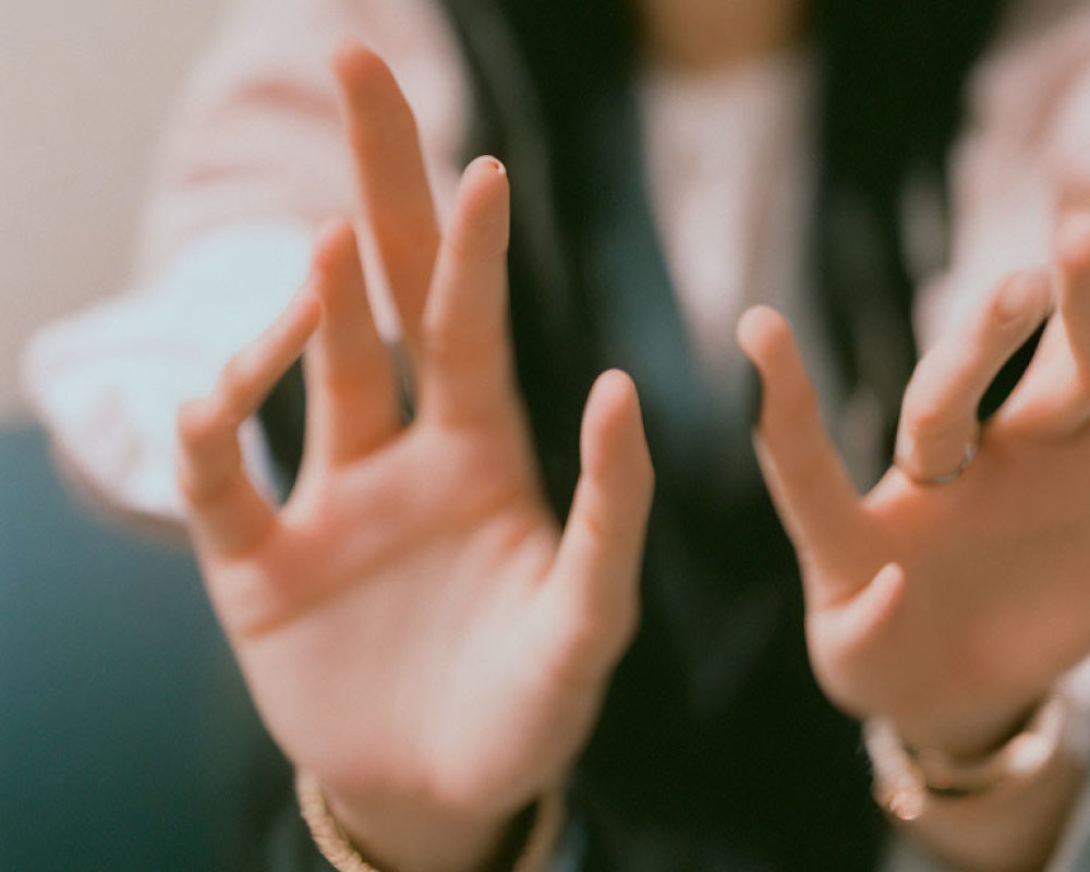 Person's Hands Gesturing in Close-Up Shot