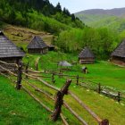 Rustic wooden houses and barns in lush green fields and rolling hills