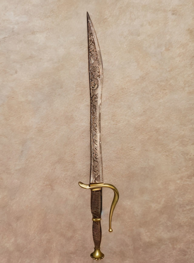 Decorative ornate sword with embellished blade and curved guard on beige background