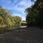 Scenic river landscape with rainbow light spots and lush greenery