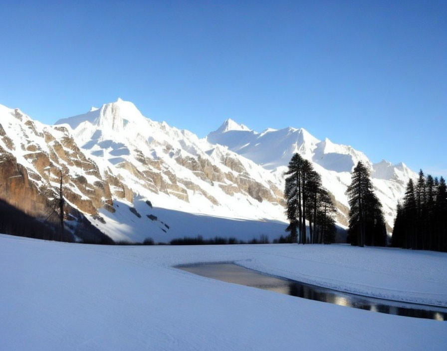 Snowy mountains, frozen river, and evergreen trees in winter landscape