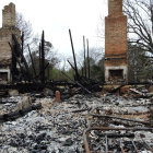 Dilapidated village scene with broken structures and leafless trees