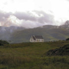 Tranquil landscape with white house and red roof nestled in grassy hills