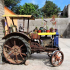 Colorful Vintage Tractor with Floral Patterns and Rural Scene