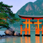 Scenic painting of orange torii gate in water with mountain backdrop