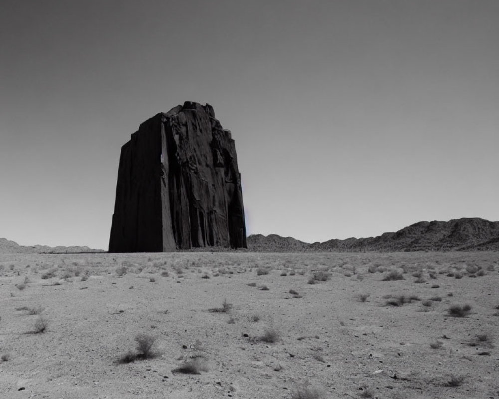 Prominent Monolithic Rock Formation in Barren Desert Landscape