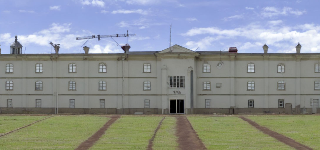 Symmetrical windows and antennas on weathered two-story building