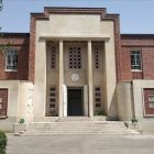 Islamic architecture with arched doorways, ornate windows, and domes in a courtyard setting.