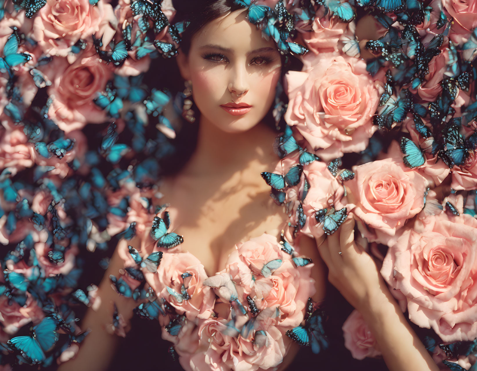 Woman with pink roses and blue butterflies in a dreamy setting