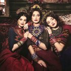 Three Women Illustration in Ornate Clothing on Couch