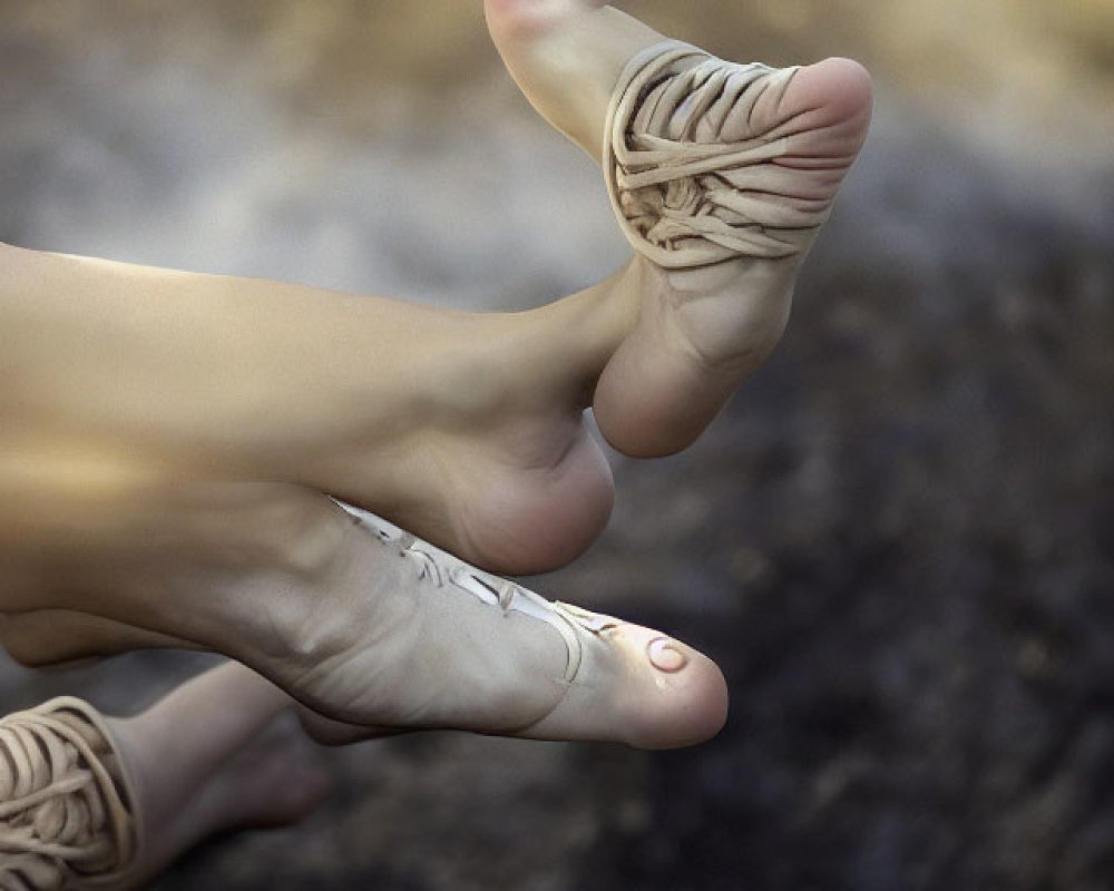 Feet with one unraveling into strings on blurred background