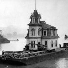 Ornate multi-story riverboat at dock in misty twilight