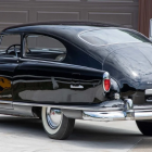 Vintage Classic Car with Blue Finish and Chrome Details in Indoor Setting