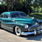 Vintage Turquoise Car with Chrome Details and Front Grille Parked Outdoors