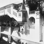 Monochrome photo of ornate classical building corner with balconies and trailing plants