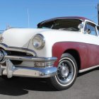 Vintage Car with White & Purple Paint, Chrome Grille, Custom Wheels, Parked Under Blue Sky