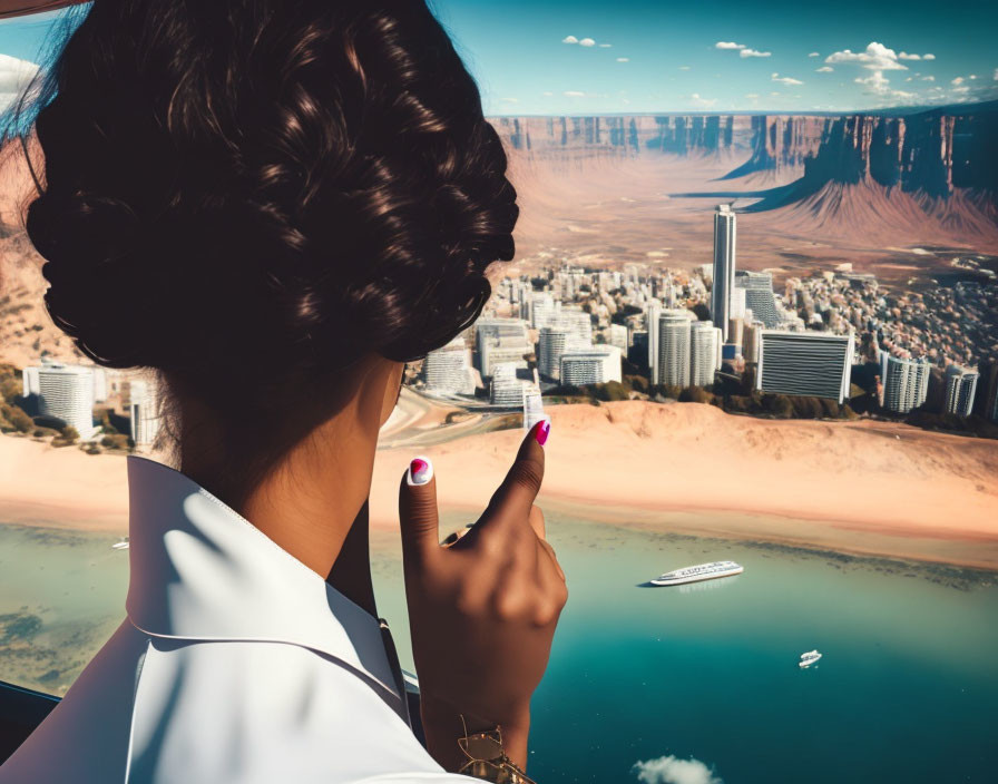 Woman with updo hairstyle pointing at cityscape, water body, boats, and mountain.