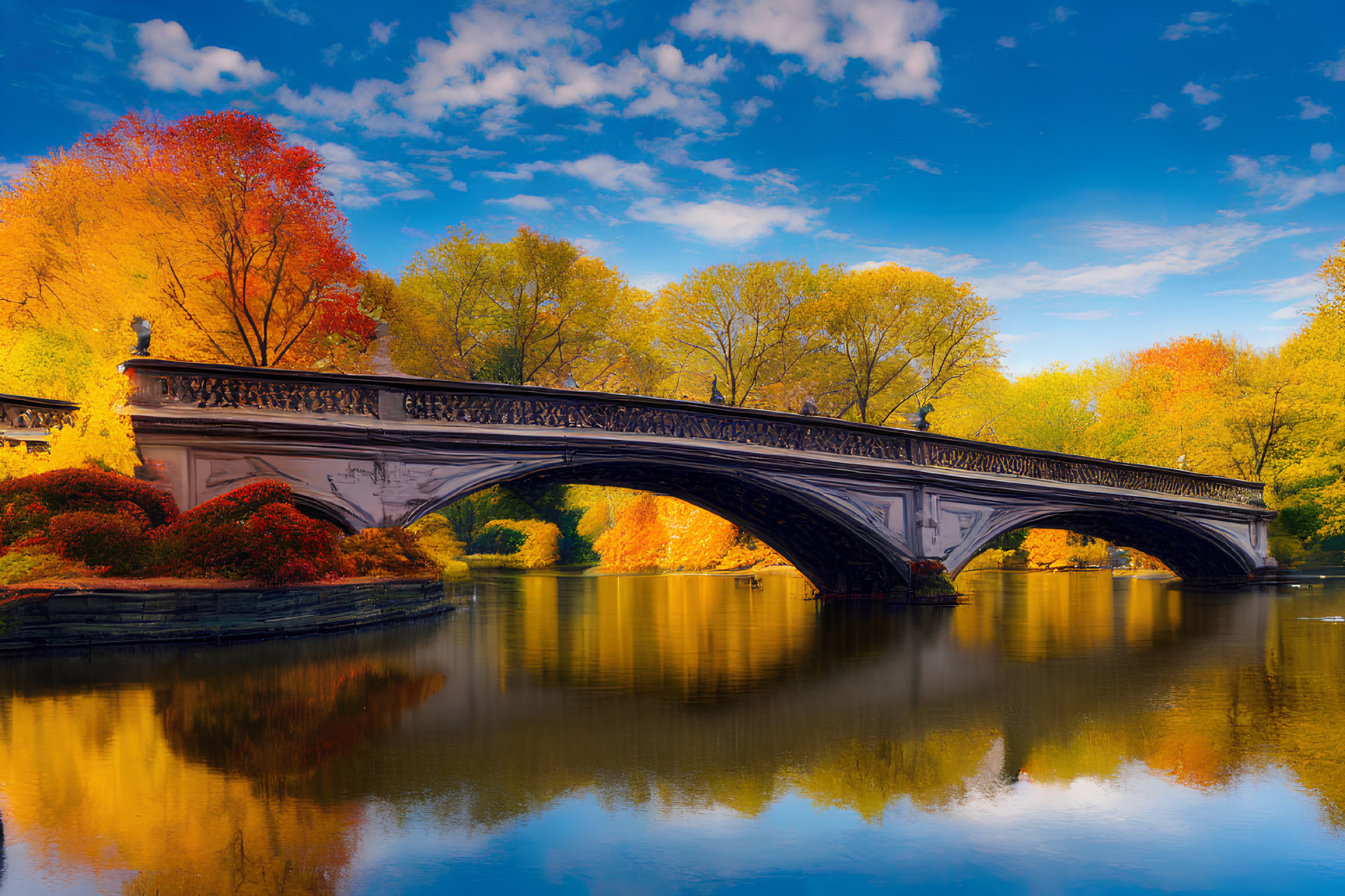 Ornate bridge over tranquil river with autumn foliage and clear blue sky