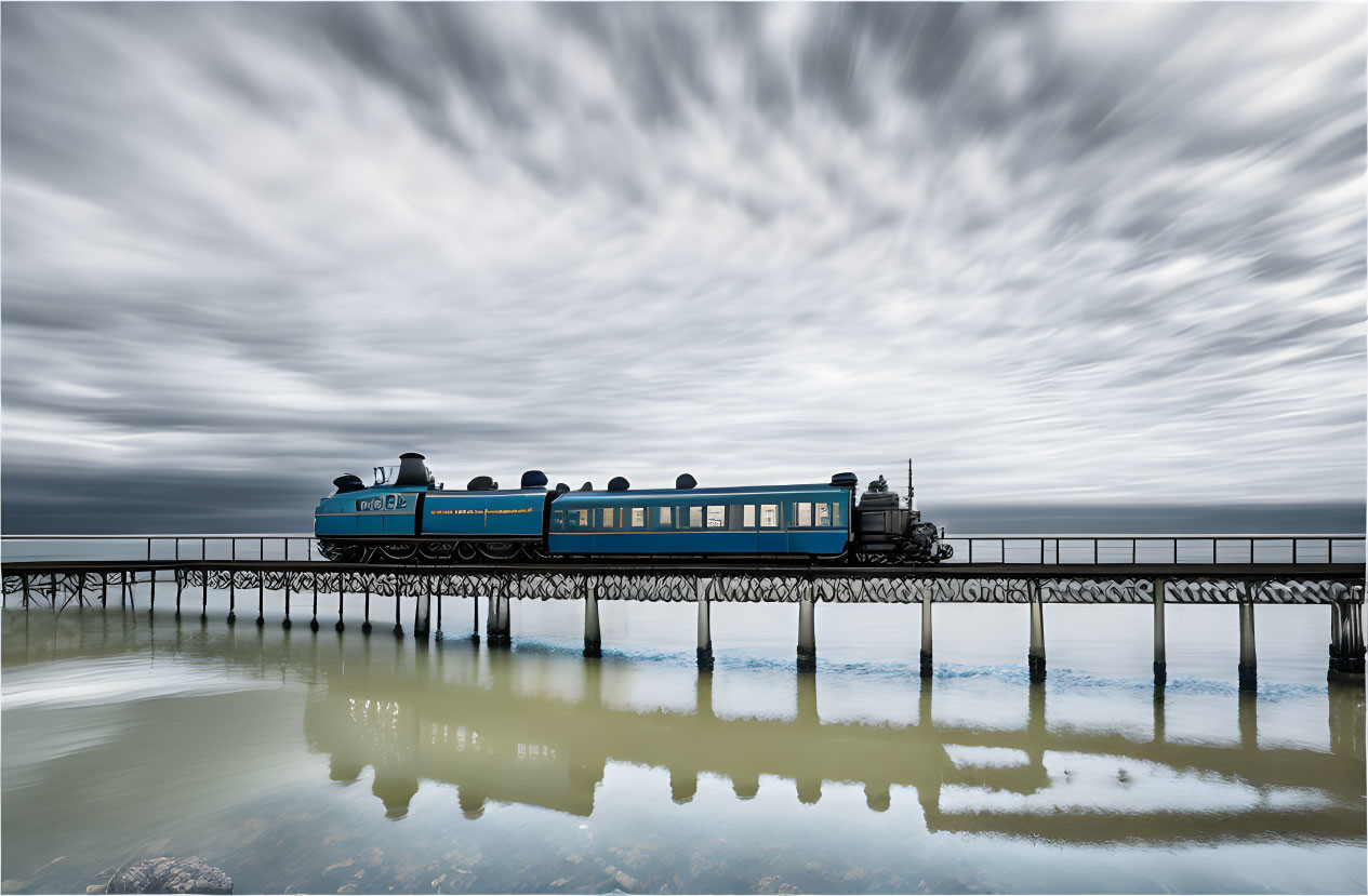 Blue train crossing pier over calm waters under dramatic cloudy sky