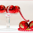 Red Christmas Baubles with Snowflake Designs on Glass Stand in Snowy Setting