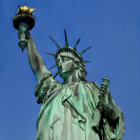 Statue of Liberty with melting effect and blue hues in clear sky