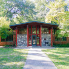 Modern House Surrounded by Gardens and Trees with Large Windows