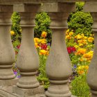 Vibrant garden scene with stone pillars and colorful flowers